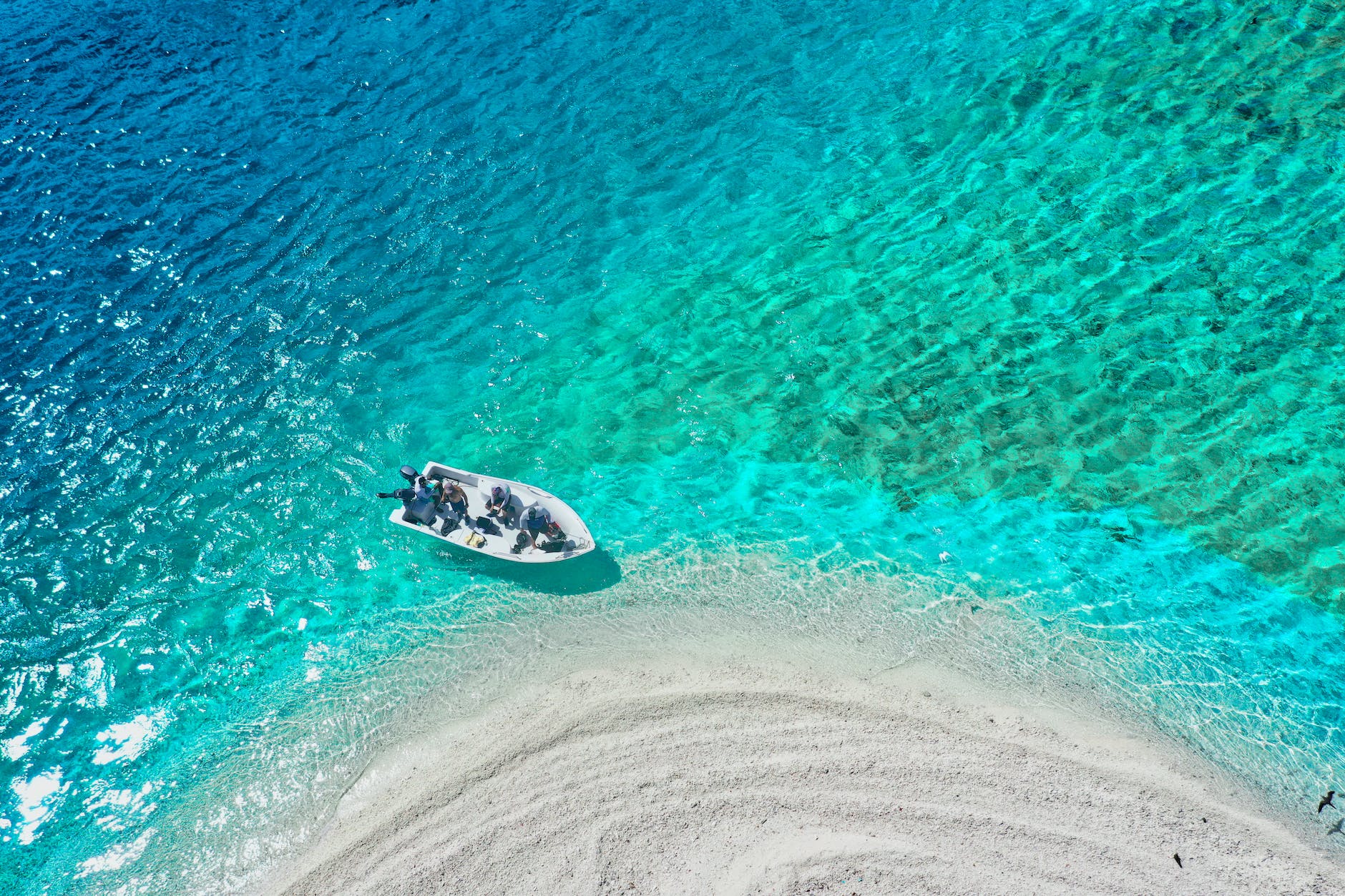 Boat anchored off the white sandbar at Ile aux Cerfs