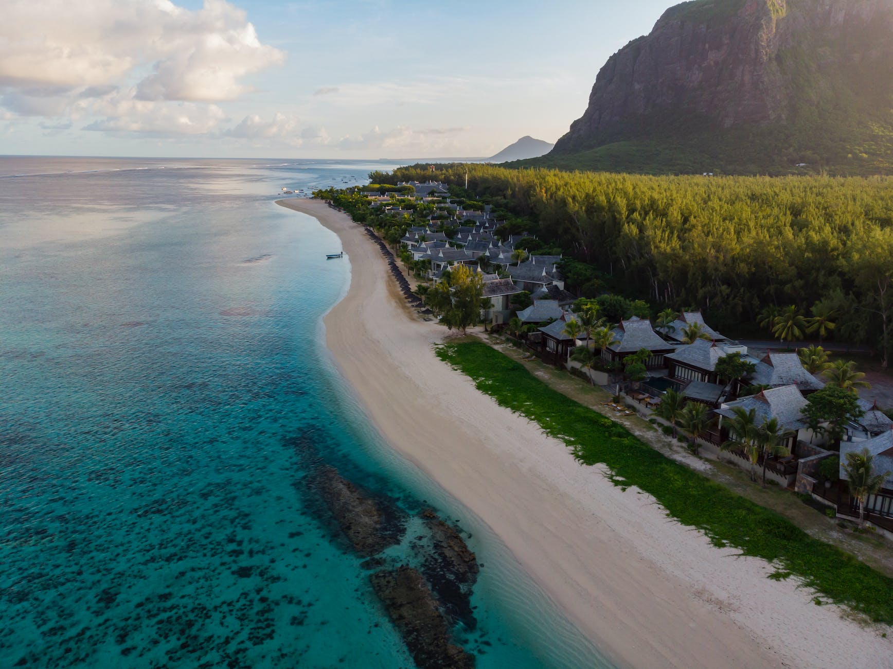 Aerial view of Le Morne, its lagoon and the mountain behind it